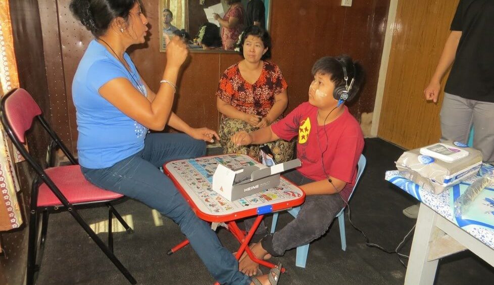 An audiologist measuring hearing levels